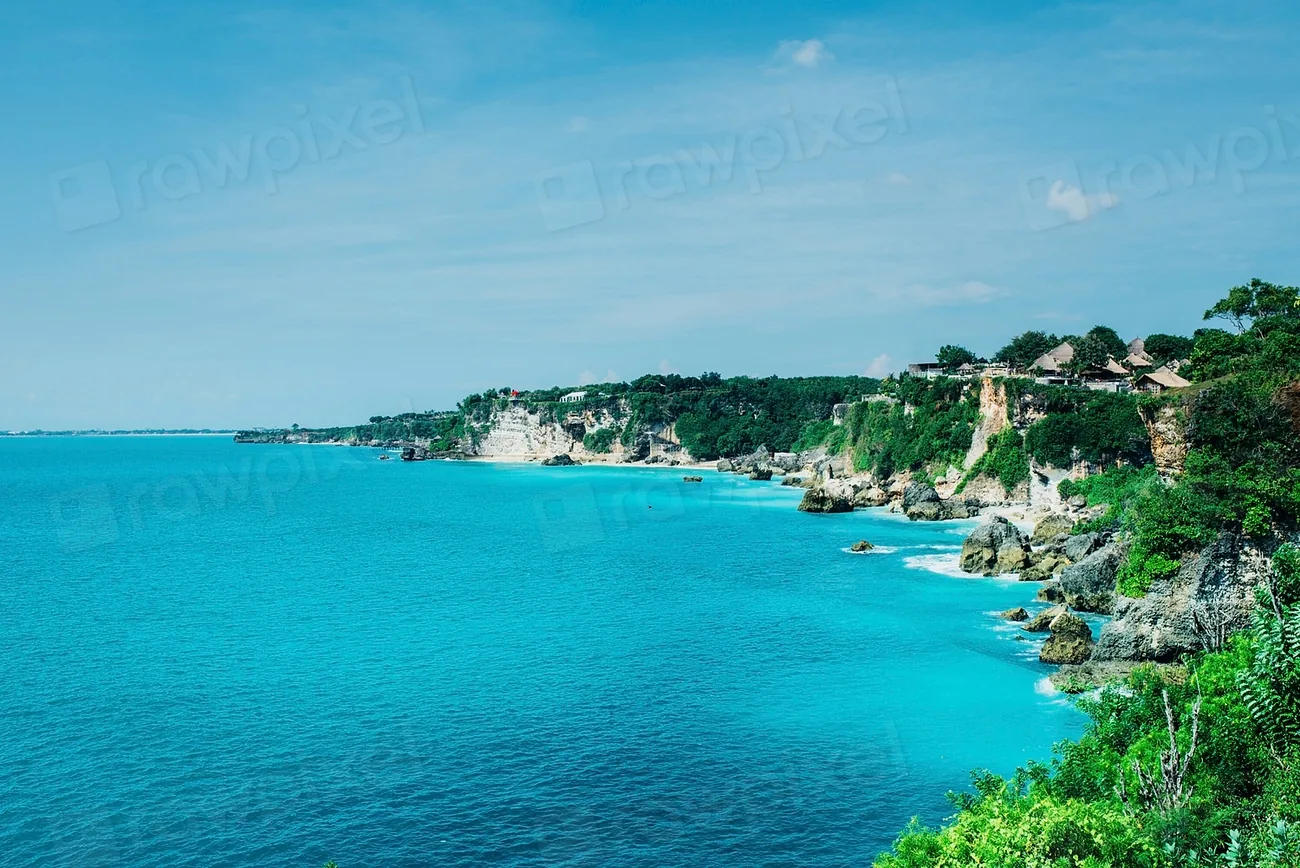 An aerial view of a turquoise coastline and village